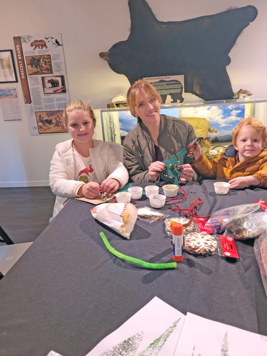 Family crafting at a museum table.