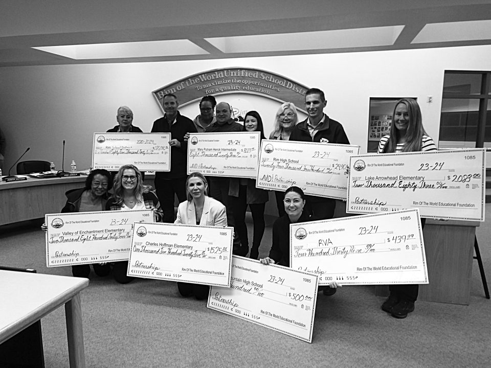 Adrianne, Lisa, Julia, Melissa and Adrianna from Glendora and Orange County enjoyed last year’s Brewfest at Tavern Bay Beach Club so much they couldn’t resist attending this year’s event. (Photos by Douglas W. Motley) Group holding large donation checks in school boardroom.