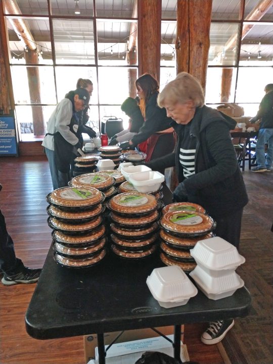 Volunteers cut the pies on Wednesday, then put slices into containers for the meals to be delivered. (Photo by Mary-Justine Lanyon)