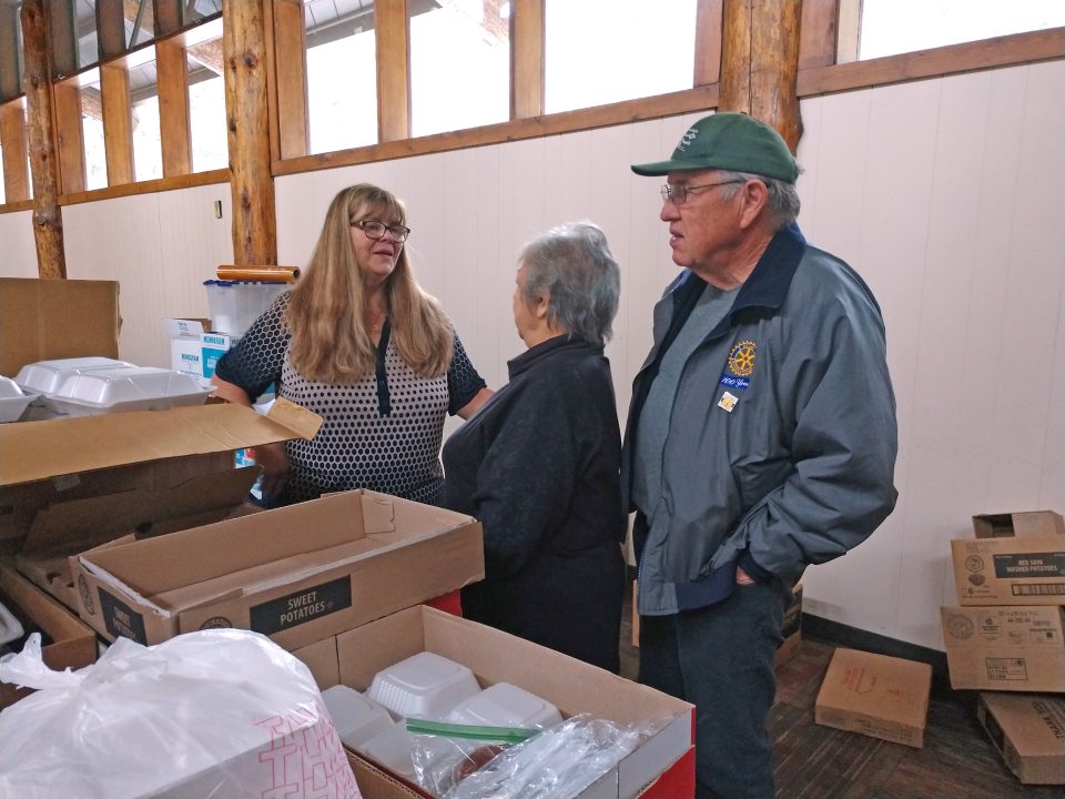 Volunteer coordinator Jeri-Lynn Miller discusses delivery plans with fellow Rotarians Linda and Stanley Oswalt. (Photo by Mary-Justine Lanyon)