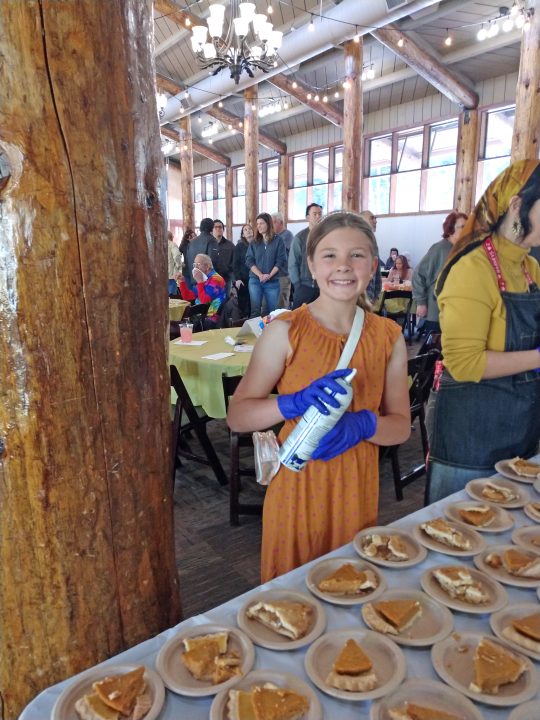 Joy Beitzel, a member of the fifth-grade EarlyAct Club, volunteered with her family at the dinner. She was an enthusiastic dispenser of whipped cream.