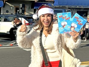 Cecilia Ponce de Leon, a member of the Rotary Club of Lake Arrowhead, helped pass out books to children along the parade route.