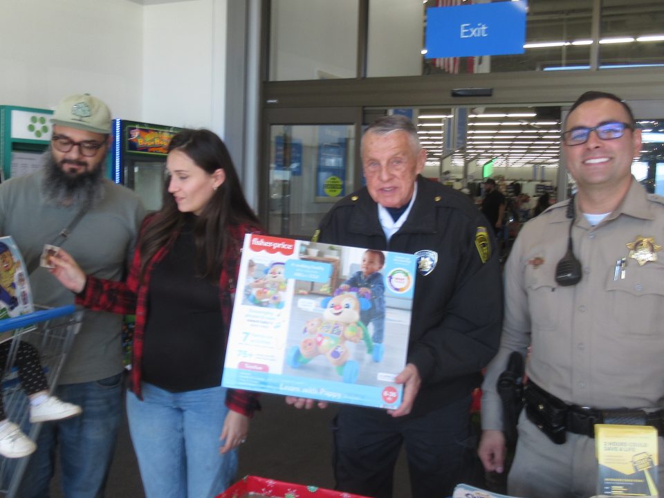 A couple from Los Angles donated a Fisher Price toy as they exited the store.