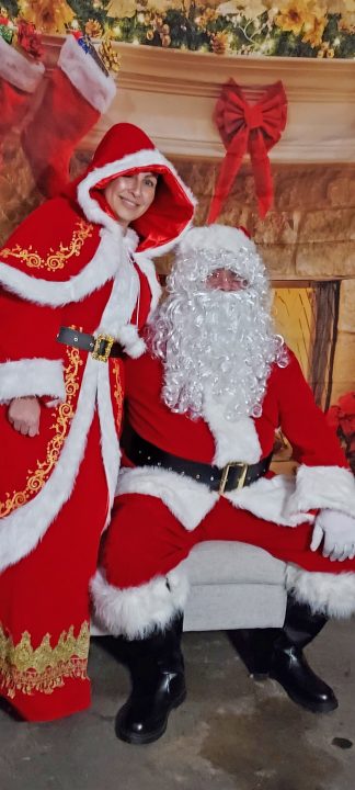 Santa and Mrs. Claus greeted visitors at their Darfo Court home surrounded by candy canes. Their house tied for second place.