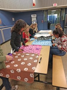 Back inside, the girls decorated blankets for cats.