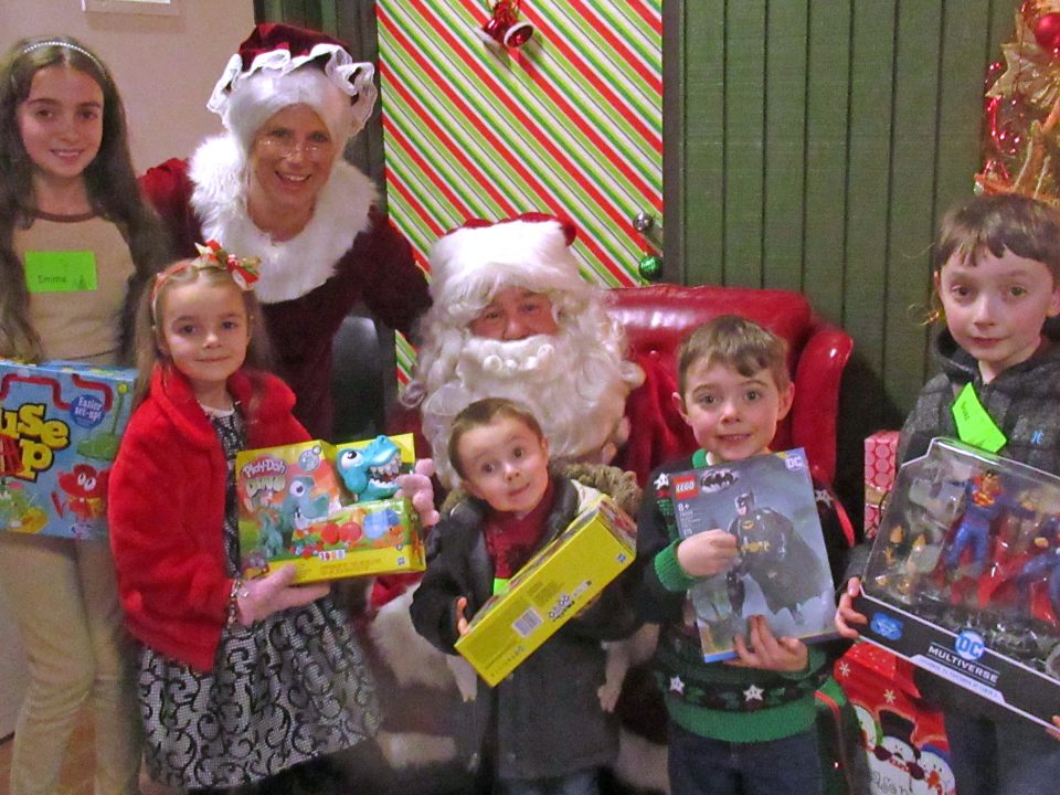Adrianne, Lisa, Julia, Melissa and Adrianna from Glendora and Orange County enjoyed last year’s Brewfest at Tavern Bay Beach Club so much they couldn’t resist attending this year’s event. (Photos by Douglas W. Motley) Smiling children with Santa and toys at Christmas event.