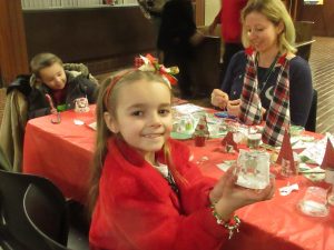 Eight-year-old Ezra holds a cup she decorated.