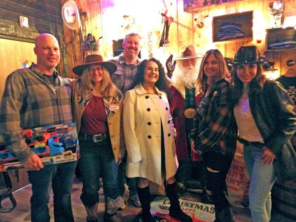 Adrianne, Lisa, Julia, Melissa and Adrianna from Glendora and Orange County enjoyed last year’s Brewfest at Tavern Bay Beach Club so much they couldn’t resist attending this year’s event. (Photos by Douglas W. Motley) Group posing with cowboy Santa in rustic setting.