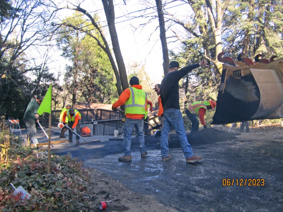 Crews applying asphalt on Mercury Way on Dec. 6.