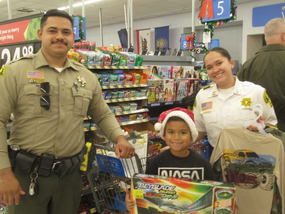 Seven-year-old Abel, accompanied by Deputy Swanson and Law Enforcement Explorer V. Barron, was beaming with pride as he stood next to a shopping cart filled with lots of cool stuff. 