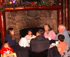 family circle by the restaurant’s fireplace encompasses Don and Beth Johnson (right) with their son-in-law, Brandon Le, daughter, Bonnie, and three grandchildren. Recently relocated to Indiana, the Le family was visiting for Christmas. Don and one of the grandchildren were celebrating their birthdays.