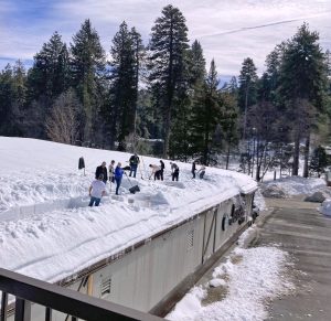 Supervisor Dawn Rowe visited the mountain during Snowmageddon and helped clear the snow from the roof of Jensen’s market. (File photo)