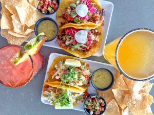 The eatery’s tacos are a fail-safe pick, especially in the company of libations such as the pomegranate margarita. (Photo courtesy of Jetties Waterfront Kitchen + Drink)
