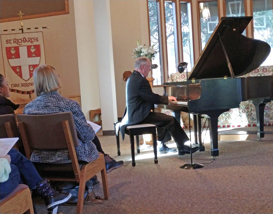 Man playing piano at church event.