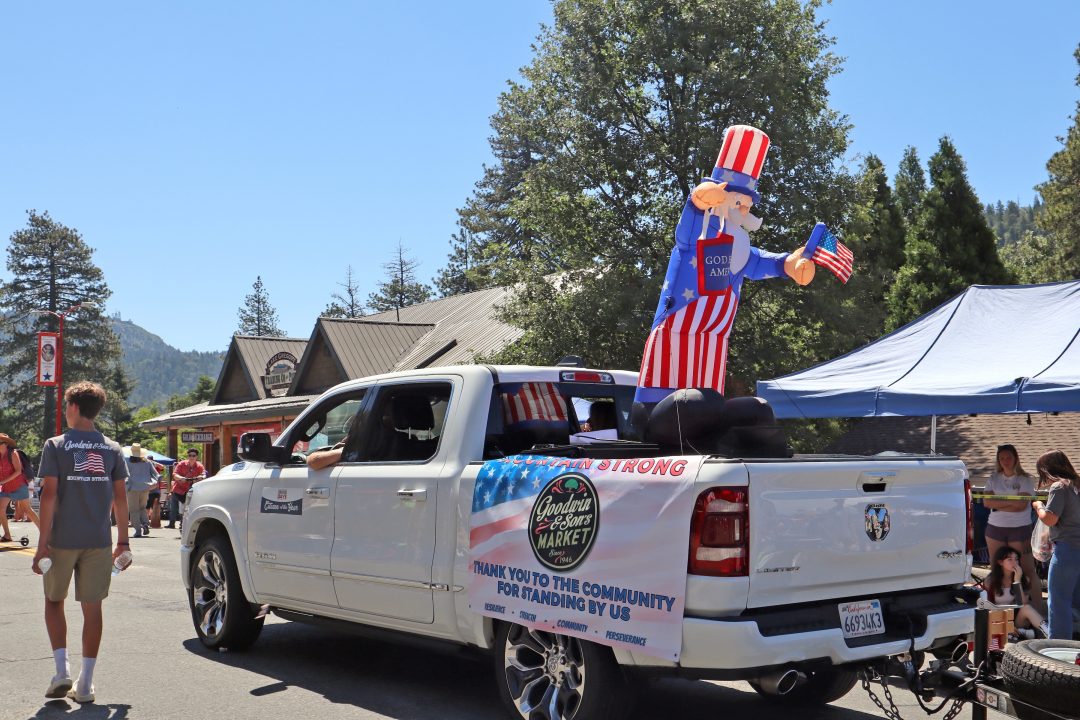Truck with inflatable Uncle Sam at parade.