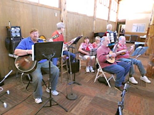 Adrianne, Lisa, Julia, Melissa and Adrianna from Glendora and Orange County enjoyed last year’s Brewfest at Tavern Bay Beach Club so much they couldn’t resist attending this year’s event. (Photos by Douglas W. Motley) Band performing folk music indoors.