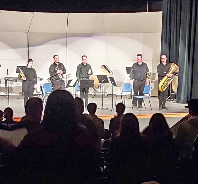 The quintet plays to a standing ovation.