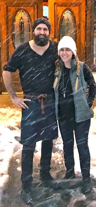 Pausing for a moment in front of their restaurant on a snowy day, John and Heather Hackney reveal that they’re ready for winter. (Photo courtesy of the Hackneys)