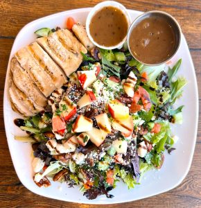 The restaurant’s seasonal salad features diced apples and grilled chicken. (Photo courtesy of The Lakefront Tap Room Bar and Kitchen)