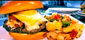 The café’s Big Texas breakfast burger is available daily until 3 p.m., along with other breakfast selections.