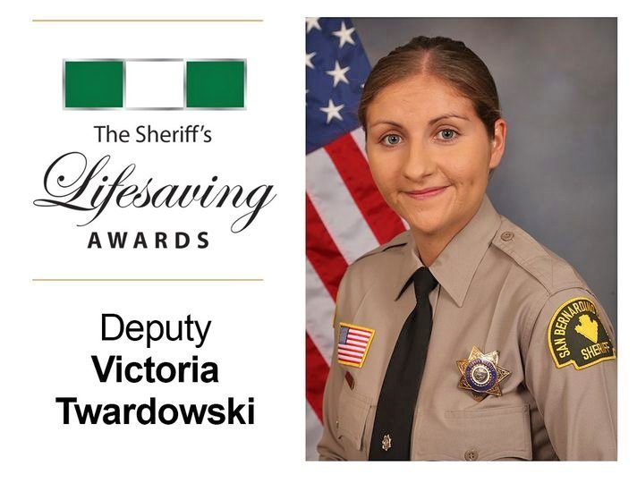 Sheriff's Lifesaving Award recipient in uniform with flag.