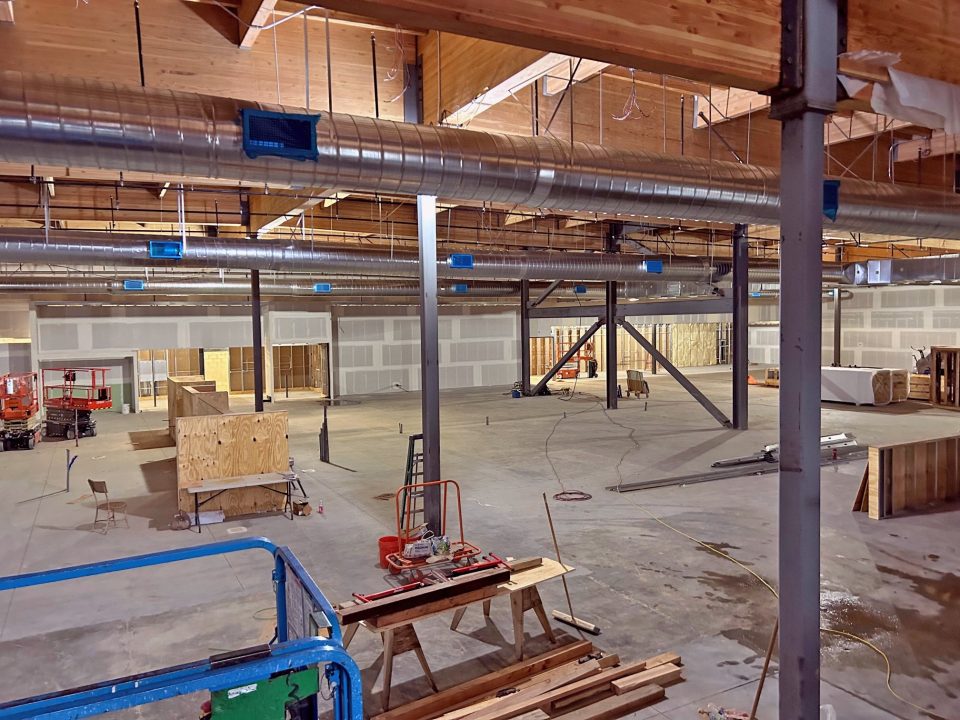 Industrial warehouse under construction with exposed ductwork.