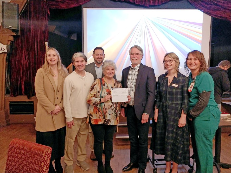 Group photo of people holding a certificate.