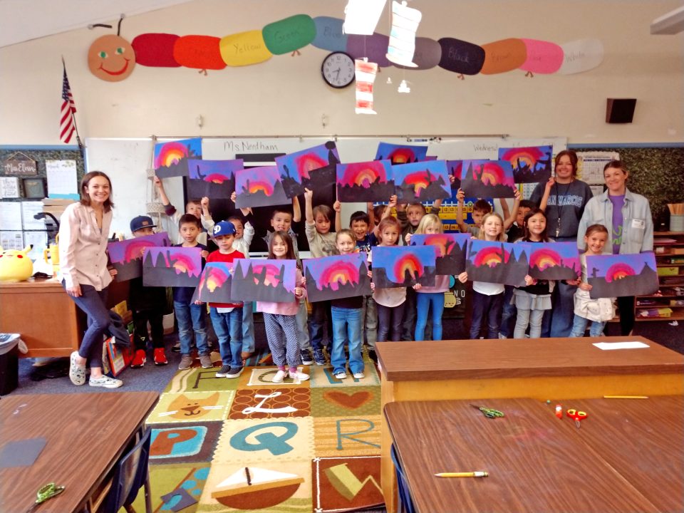 The students proudly held up their Remington-inspired artwork.