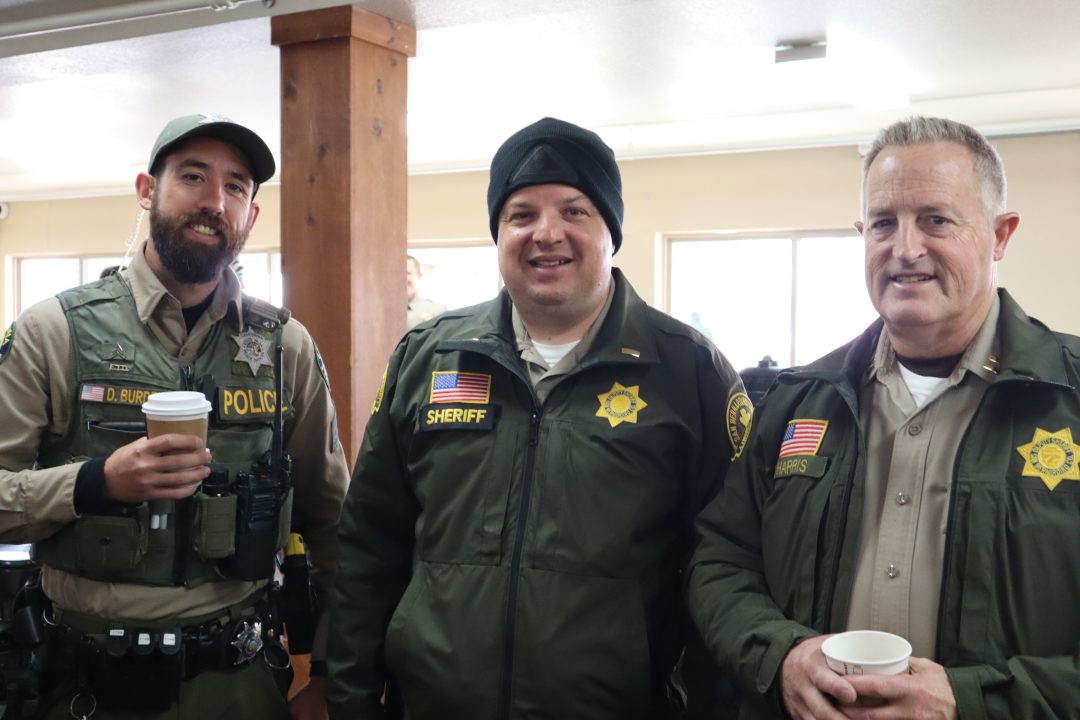 Adrianne, Lisa, Julia, Melissa and Adrianna from Glendora and Orange County enjoyed last year’s Brewfest at Tavern Bay Beach Club so much they couldn’t resist attending this year’s event. (Photos by Douglas W. Motley) Three police officers smiling indoors with coffee cups.