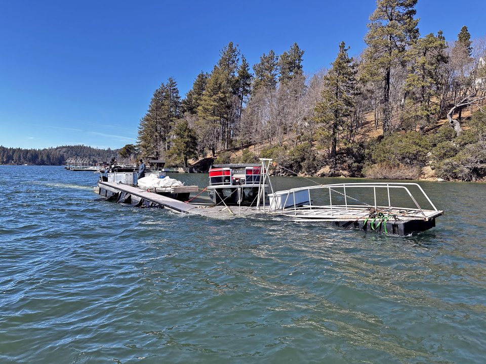 Partially submerged boat on a scenic lake.