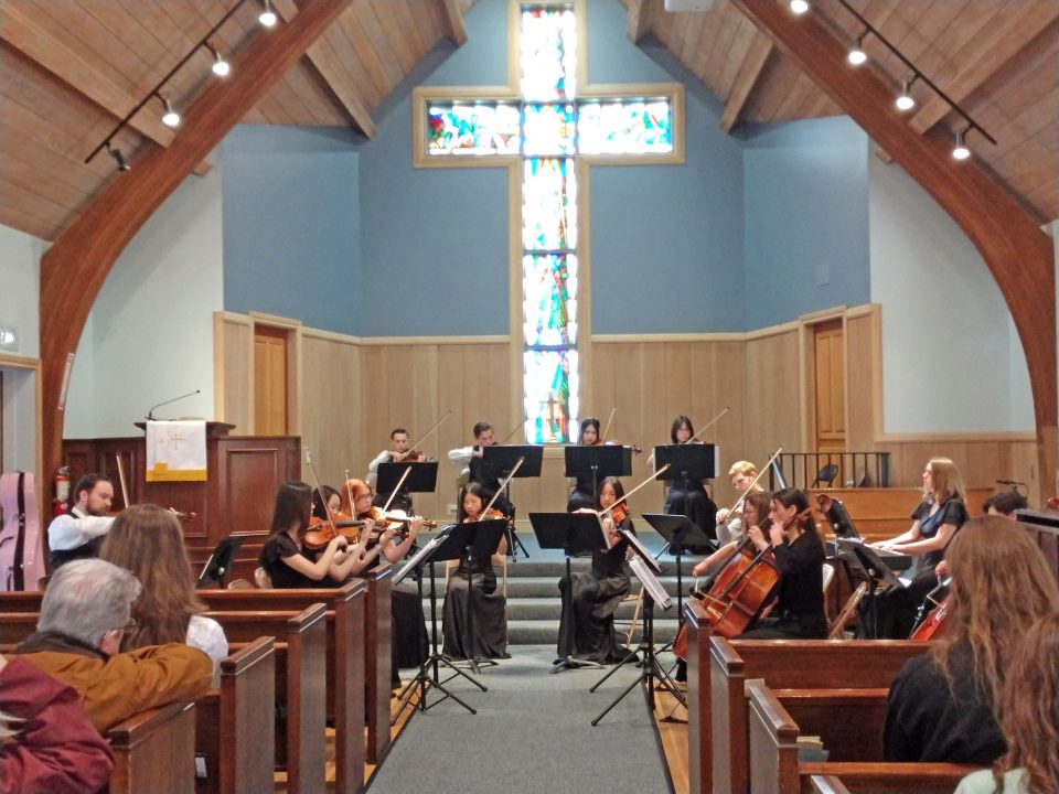 Adrianne, Lisa, Julia, Melissa and Adrianna from Glendora and Orange County enjoyed last year’s Brewfest at Tavern Bay Beach Club so much they couldn’t resist attending this year’s event. (Photos by Douglas W. Motley) String ensemble performing in church with stained glass window.