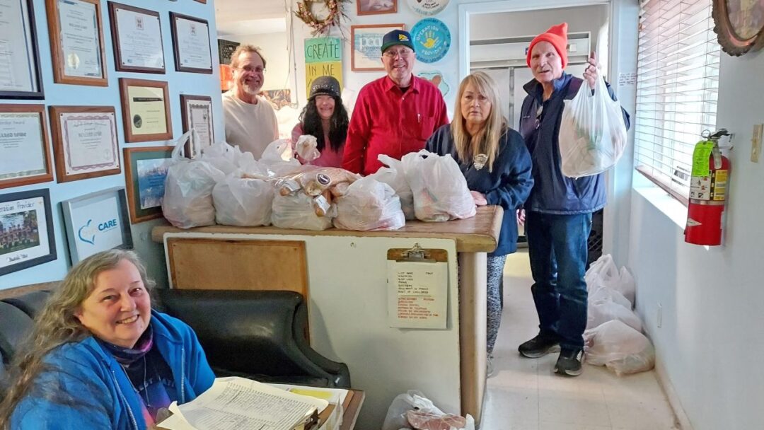 Adrianne, Lisa, Julia, Melissa and Adrianna from Glendora and Orange County enjoyed last year’s Brewfest at Tavern Bay Beach Club so much they couldn’t resist attending this year’s event. (Photos by Douglas W. Motley) Volunteers distributing food packages at community center.
