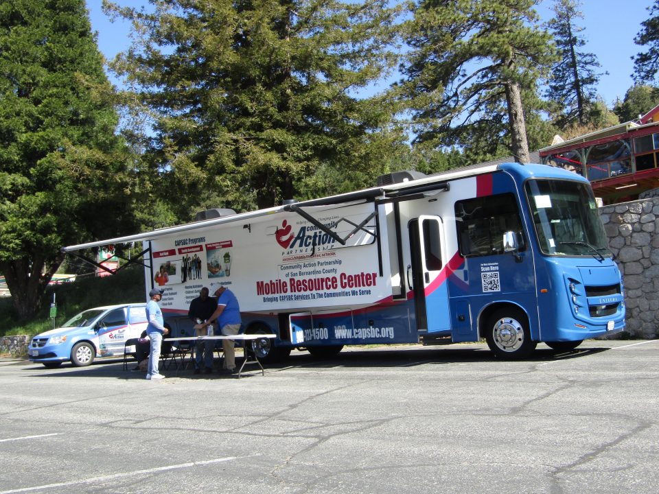 Mobile resource center with people outside.