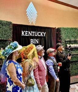 Resort General Manager Paul Medawar (center) and some of the Derby party guests watching the race intently on a big-screen TV.
