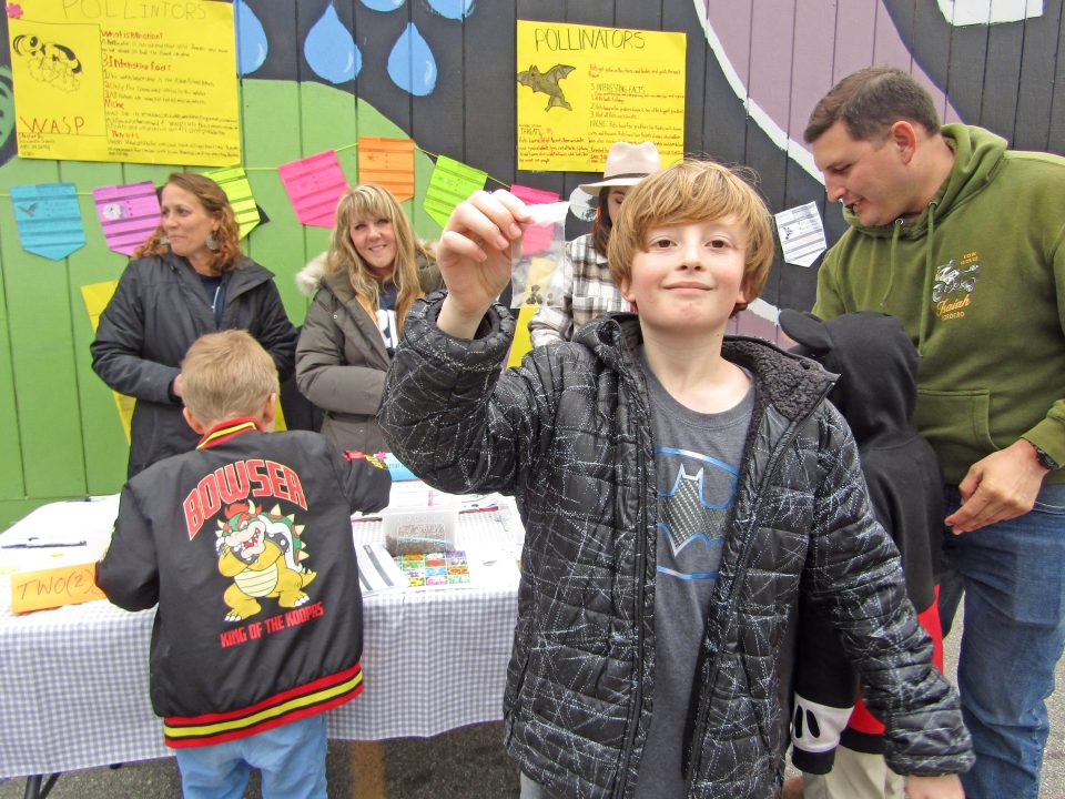 Children at educational booth about pollinators.