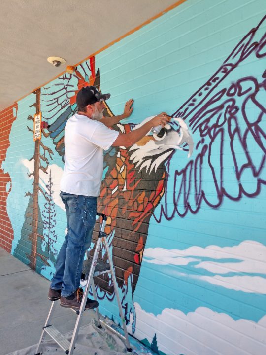 Adrianne, Lisa, Julia, Melissa and Adrianna from Glendora and Orange County enjoyed last year’s Brewfest at Tavern Bay Beach Club so much they couldn’t resist attending this year’s event. (Photos by Douglas W. Motley) Artist painting mural of eagle on wall