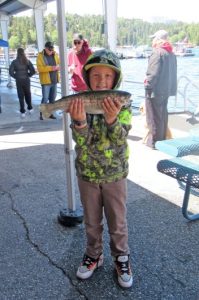 Ten-year-old Dean Janes proudly holds up his biggest trout, which weighed 2.47 pounds.