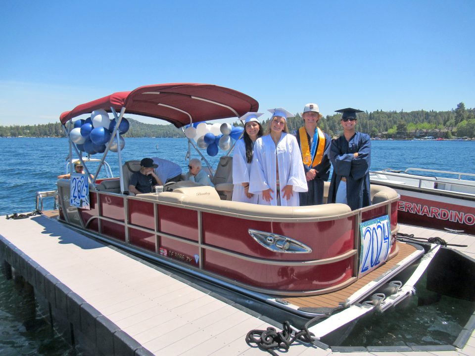 Adrianne, Lisa, Julia, Melissa and Adrianna from Glendora and Orange County enjoyed last year’s Brewfest at Tavern Bay Beach Club so much they couldn’t resist attending this year’s event. (Photos by Douglas W. Motley) Graduates on decorated boat at lake dock.