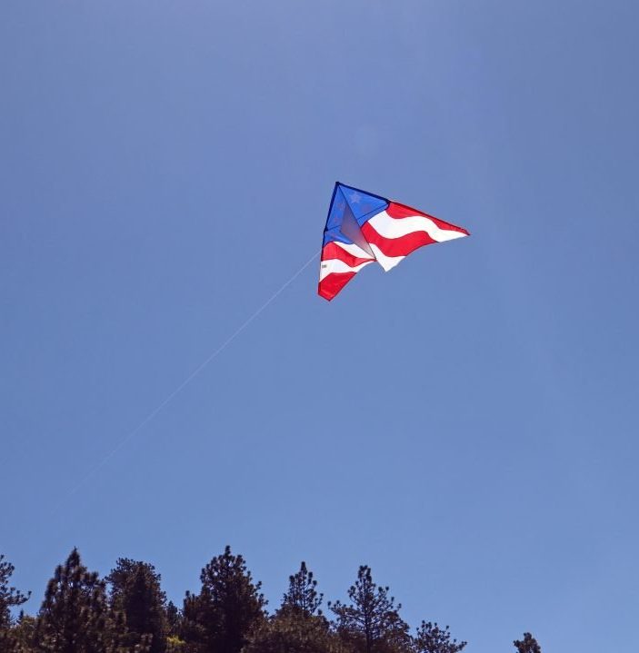 American flag kite flying in blue sky