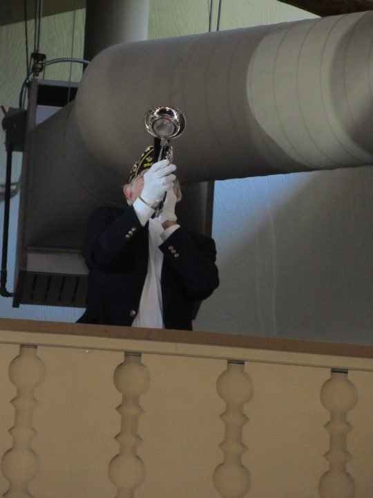 Lou Novins played Taps from the balcony at the San Moritz Lodge.