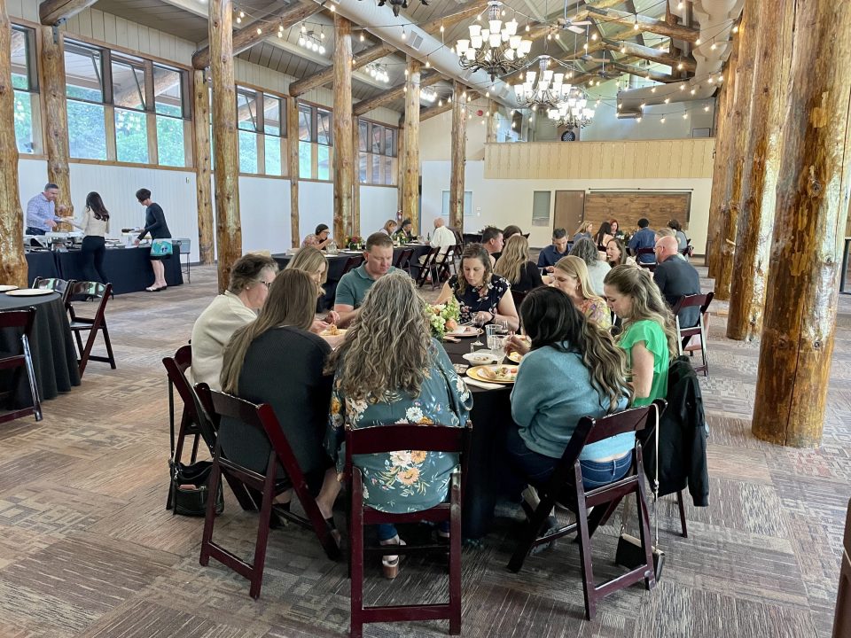 Group dining in rustic event hall.