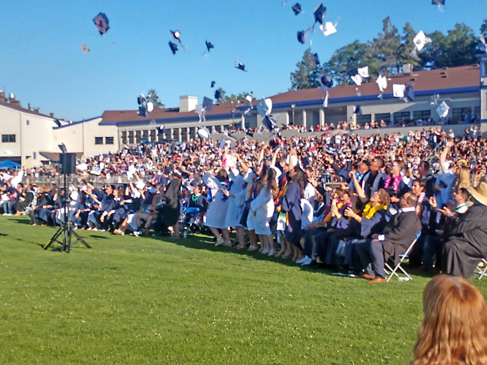 As is tradition, following the turning of their tassels, many new graduates tossed their caps in the air.