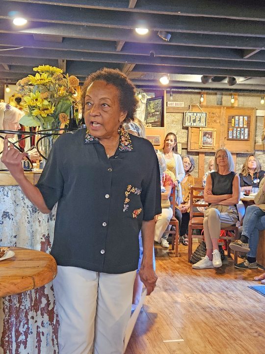 Adrianne, Lisa, Julia, Melissa and Adrianna from Glendora and Orange County enjoyed last year’s Brewfest at Tavern Bay Beach Club so much they couldn’t resist attending this year’s event. (Photos by Douglas W. Motley) Woman speaking in a cozy, rustic cafe setting.