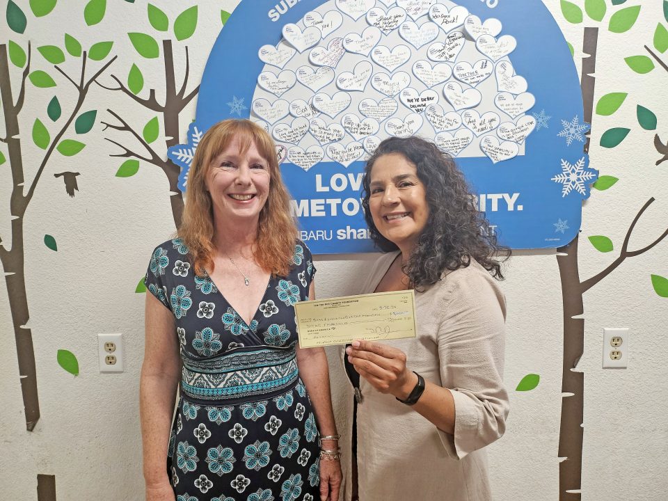 Adrianne, Lisa, Julia, Melissa and Adrianna from Glendora and Orange County enjoyed last year’s Brewfest at Tavern Bay Beach Club so much they couldn’t resist attending this year’s event. (Photos by Douglas W. Motley) Two women smiling, holding a donation check.