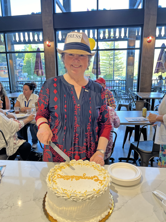 Mary-Justine Lanyon gets ready to cut her cake, congratulating her on serving as president of the Crestline-Lake Gregory Rotary Club for the past two years. (Photo by Nicole Cooper)