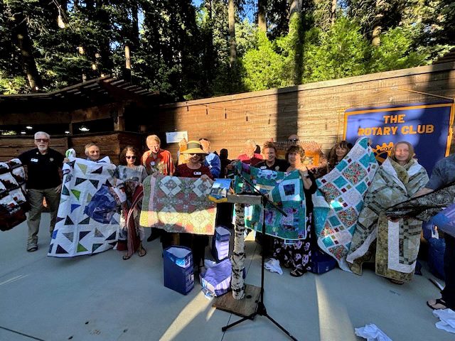 Outgoing President Teri Ostlie made quilts for her 14 board members to thank them for their support while she rebuilt her house following Snowmageddon. (Photo by Joyce Patrick Eckert)