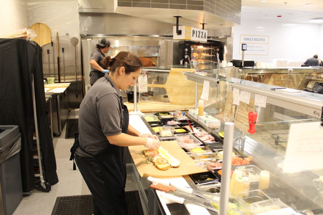 Deli worker Jackie Alexander makes a turkey foot-long sandwich for a customer.