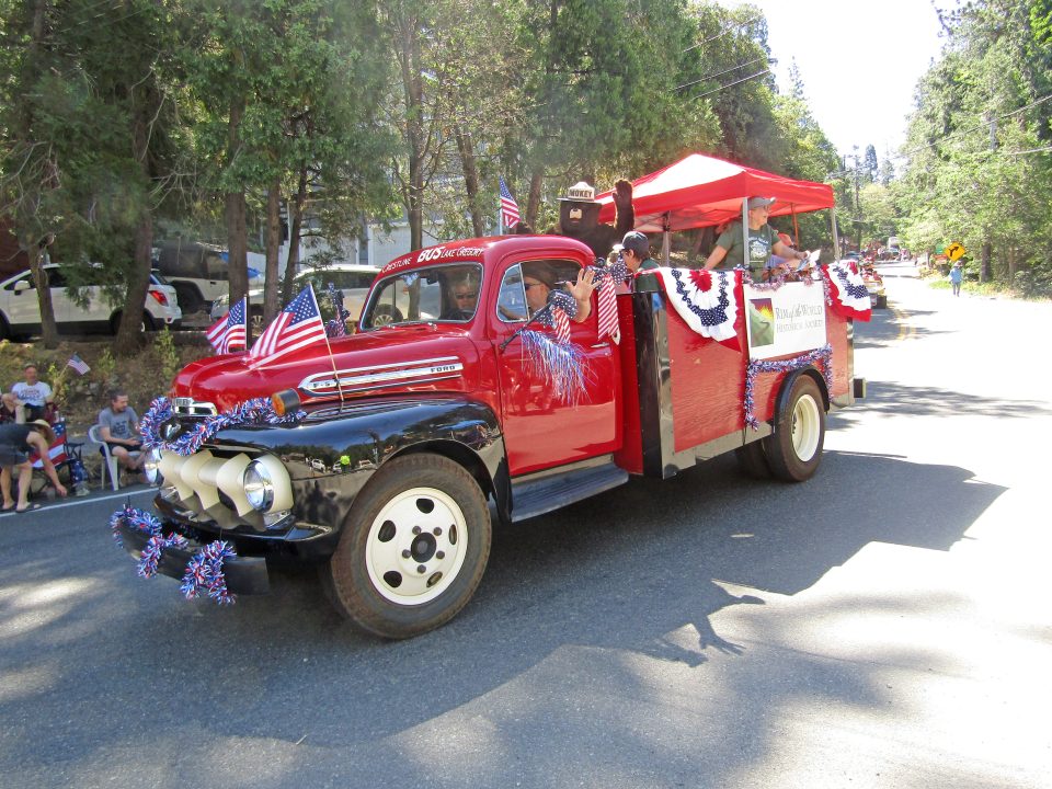 Adrianne, Lisa, Julia, Melissa and Adrianna from Glendora and Orange County enjoyed last year’s Brewfest at Tavern Bay Beach Club so much they couldn’t resist attending this year’s event. (Photos by Douglas W. Motley) Red vintage truck in patriotic parade with flags.