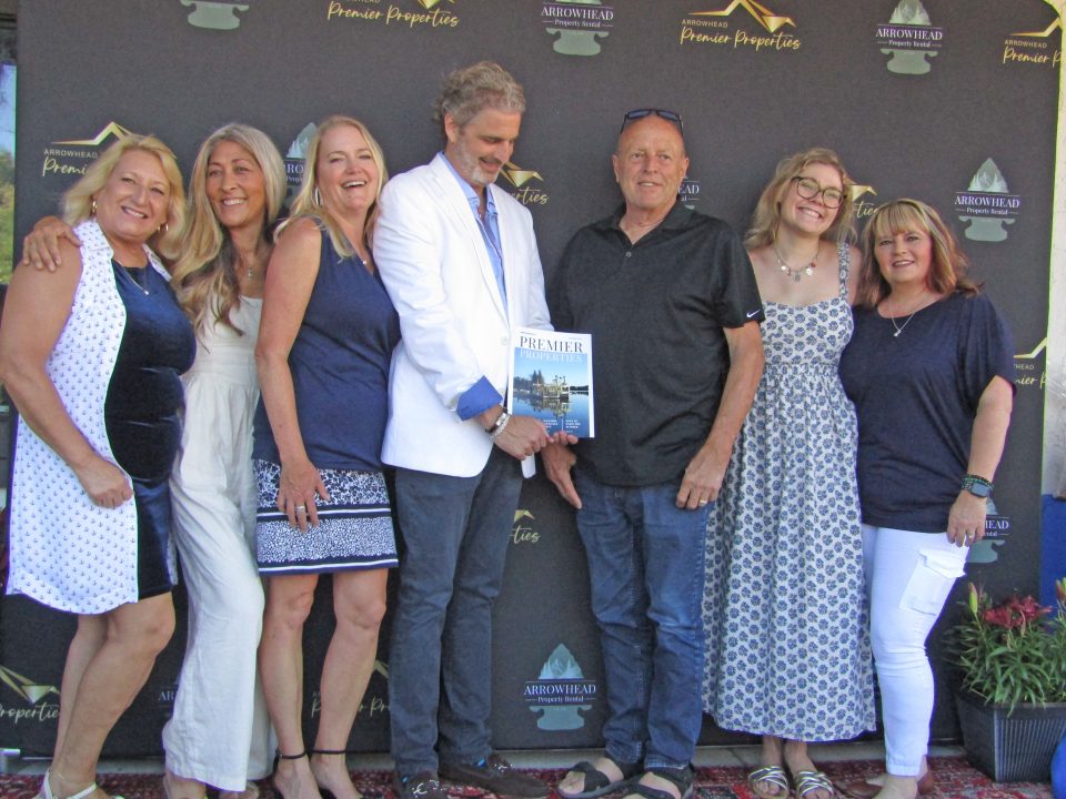 Brian Cohen, holding his new magazine, and his Arrowhead Premier Properties staff.