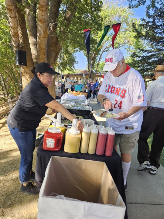 Tom Bachman fills his plate at one of the Wicked Sausage booth.